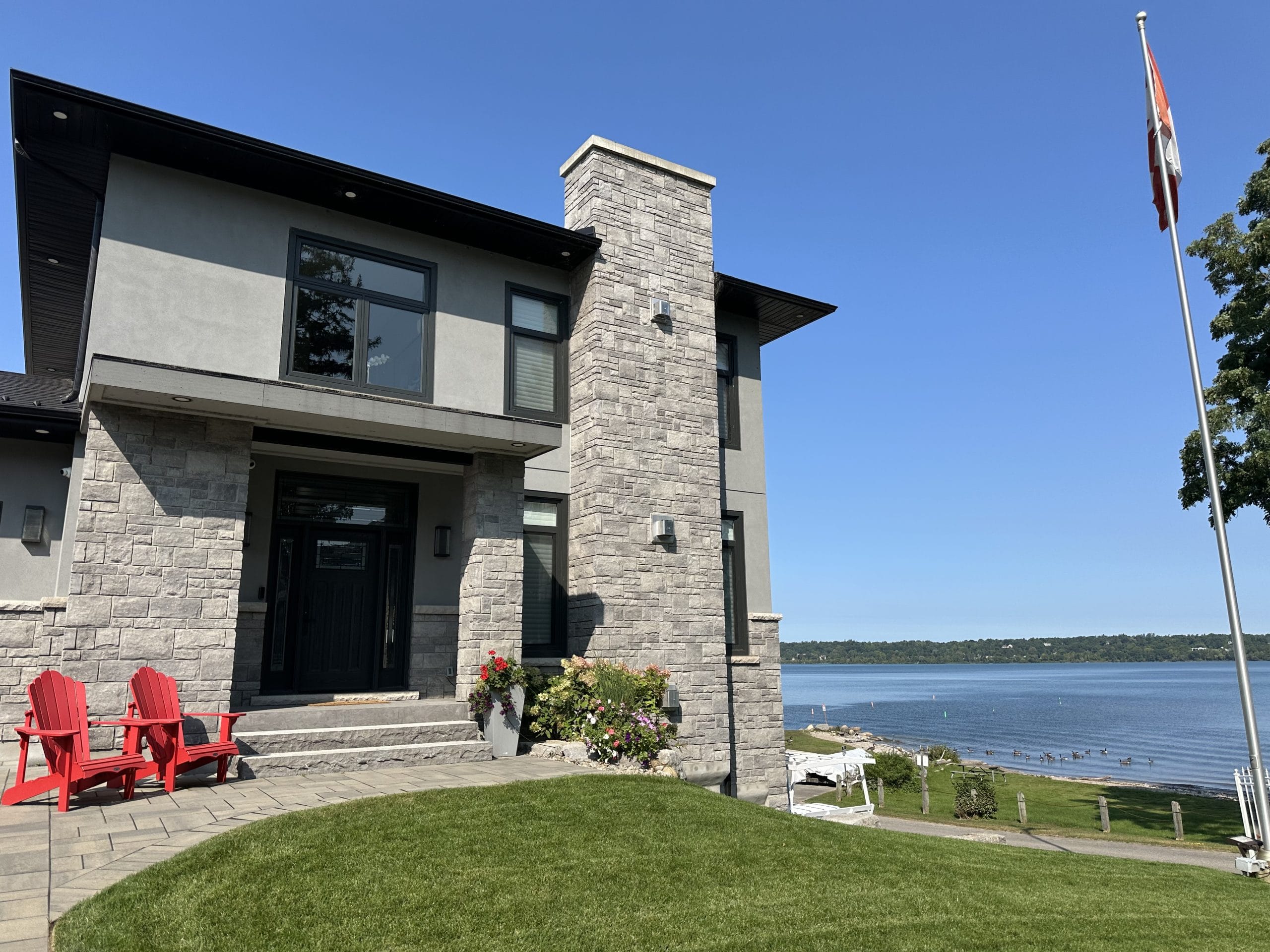 Top Fall Home Maintenance Tips View of house on waterfront, late summer