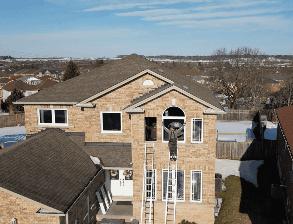 Drone shot of team working on window and door installation exterior
